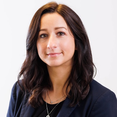 Photo of Jacqueline Evans, a smiling woman with long dark brown hair