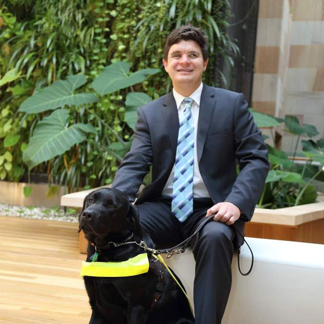 Associate Professor Harpur and his guide dog, Sean.