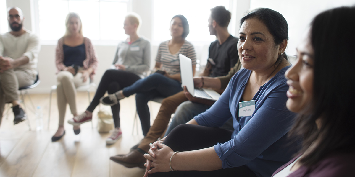 Group of people seated in a semi circle